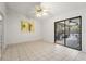 Bright living room featuring tile flooring and sliding doors to an enclosed patio at 13991 Coronado Dr, Spring Hill, FL 34609