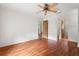 Spacious main bedroom with wood floors, ceiling fan, and two doorways at 13991 Coronado Dr, Spring Hill, FL 34609