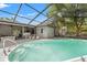 Screened-in pool and patio includes a hot tub and outdoor seating at 13991 Coronado Dr, Spring Hill, FL 34609