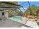 Enclosed pool area features a swimming pool, a hot tub, and seating at 13991 Coronado Dr, Spring Hill, FL 34609