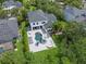 Aerial view of backyard featuring custom pool, spa, outdoor seating and mature landscaping at 14617 Galt Lake Dr, Tampa, FL 33626