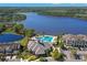 Aerial view of a luxurious pool with a clubhouse and beautiful lake at 14617 Galt Lake Dr, Tampa, FL 33626