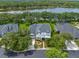 Stunning aerial view of home showcasing landscaping and neighborhood lakeside at 14617 Galt Lake Dr, Tampa, FL 33626