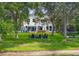 Spacious fenced yard leading to the lake, featuring a fire pit and playground at 14617 Galt Lake Dr, Tampa, FL 33626