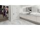 Bright bathroom showcasing a double sink vanity with an illuminated mirror and walk in closet at 14617 Galt Lake Dr, Tampa, FL 33626