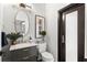 Stylish powder room with modern vanity, designer mirror, and black accents at 14617 Galt Lake Dr, Tampa, FL 33626