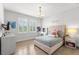 Well-lit bedroom with a pink bed frame, a vanity, and two windows at 14617 Galt Lake Dr, Tampa, FL 33626