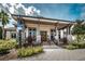 Clubhouse featuring a covered entryway with stone accents and well-maintained landscaping at 14617 Galt Lake Dr, Tampa, FL 33626