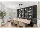 Dining room features a long table, modern lighting, built-in shelves, and views to the exterior at 14617 Galt Lake Dr, Tampa, FL 33626