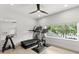 Well-lit exercise room featuring modern equipment and a large window offering serene views of the outdoors at 14617 Galt Lake Dr, Tampa, FL 33626