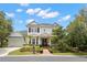 A well-maintained, two-story home featuring a manicured lawn and elegant landscaping, framed by mature trees at 14617 Galt Lake Dr, Tampa, FL 33626