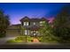 Two-story home with a manicured lawn and garden, a two car garage, and a walkway to the front door at 14617 Galt Lake Dr, Tampa, FL 33626