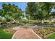 Community water fountain surrounded by lush landscaping, brick walkways, and mature trees at 14617 Galt Lake Dr, Tampa, FL 33626