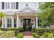 Close-up of a welcoming entryway featuring a wreath, brick path, potted greenery, and elegant architectural details at 14617 Galt Lake Dr, Tampa, FL 33626