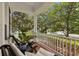 Relaxing front porch with comfortable seating and a serene view of the surrounding greenery at 14617 Galt Lake Dr, Tampa, FL 33626