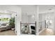 Open hallway with modern railings offering a view of the stylish living room with a cozy fireplace below at 14617 Galt Lake Dr, Tampa, FL 33626