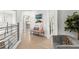 Bright hallway featuring light wood floors, a stylish bench, and artwork, creating a welcoming and modern space at 14617 Galt Lake Dr, Tampa, FL 33626