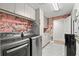 Functional laundry room equipped with modern washer and dryer units and ample storage at 14617 Galt Lake Dr, Tampa, FL 33626