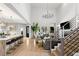 Bright, open living room boasts high ceilings, statement chandelier, and a modern staircase at 14617 Galt Lake Dr, Tampa, FL 33626
