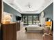 Spacious primary bedroom with tray ceiling, large windows, and serene backyard view at 14617 Galt Lake Dr, Tampa, FL 33626