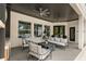Covered outdoor living area with ceiling fans and stylish seating area at 14617 Galt Lake Dr, Tampa, FL 33626