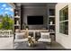 Covered outdoor living area with TV, shelving, and comfortable seating at 14617 Galt Lake Dr, Tampa, FL 33626