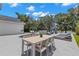 Outdoor patio area with dining table, chairs and lounge seating overlooks a pool and lush, private backyard at 14617 Galt Lake Dr, Tampa, FL 33626