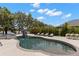 Enjoy the backyard with a pool and lounge chairs that offer stunning views of the nearby lake and lush landscaping at 14617 Galt Lake Dr, Tampa, FL 33626