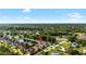 An aerial view shows the house in the neighborhood, with landscaping and a pond nearby at 15415 Otto Rd, Tampa, FL 33624