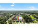 An aerial view showcases the house in the neighborhood, with landscaping and a lake nearby at 15415 Otto Rd, Tampa, FL 33624