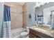 Bathroom with a combination shower and tub, granite countertop, and neutral walls at 15415 Otto Rd, Tampa, FL 33624