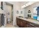 Bathroom with a large vanity, granite countertop, and coastal decor elements at 15415 Otto Rd, Tampa, FL 33624