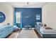 room with a blue accent wall, comfortable rug, and decorative wall art at 15415 Otto Rd, Tampa, FL 33624