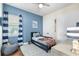 Cozy bedroom with striped curtains, soft rug, and a decorative nautical theme at 15415 Otto Rd, Tampa, FL 33624
