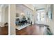 Bright dining room featuring hardwood floors, chandelier, and a view of the double front doors at 15415 Otto Rd, Tampa, FL 33624
