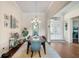 Bright dining room featuring hardwood floors, chandelier, and a view of the double front doors at 15415 Otto Rd, Tampa, FL 33624