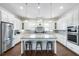 Gourmet kitchen featuring white cabinets, an island with seating, and stainless steel appliances at 15415 Otto Rd, Tampa, FL 33624