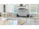 Beautiful kitchen with custom cabinets, granite counters, tile backsplash, and stainless steel appliances at 15415 Otto Rd, Tampa, FL 33624