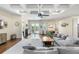 Cozy living room featuring hardwood floors, coffered ceiling, and comfortable grey couches at 15415 Otto Rd, Tampa, FL 33624