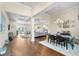 Open-concept floor plan featuring hardwood floors, coffered ceiling, and a view of the kitchen at 15415 Otto Rd, Tampa, FL 33624