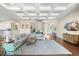 Open-concept living room featuring a coffered ceiling, hardwood floors and access to other living spaces at 15415 Otto Rd, Tampa, FL 33624