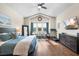 Large main bedroom features a ceiling fan, seating area, and ample natural light at 15415 Otto Rd, Tampa, FL 33624