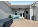 Covered patio with comfortable seating, ceiling fan, and brick pavers at 15415 Otto Rd, Tampa, FL 33624