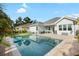Beautiful backyard pool with brick patio and manicured lawn, perfect for outdoor entertaining at 15415 Otto Rd, Tampa, FL 33624