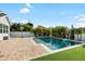 Inviting backyard pool featuring a brick patio, surrounded by lush tropical landscaping at 15415 Otto Rd, Tampa, FL 33624