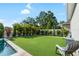 Large backyard with putting green, perfect for recreational activities and outdoor relaxation at 15415 Otto Rd, Tampa, FL 33624