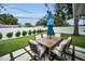 Beautiful backyard featuring a patio set, lush artificial turf, and manicured landscaping at 1557 77Th N Ave, St Petersburg, FL 33702
