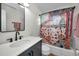 Stylish bathroom features a modern vanity, decorative shower curtain, and updated fixtures at 1557 77Th N Ave, St Petersburg, FL 33702