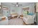 Charming Bedroom featuring hardwood floors, patterned rug and light green striped accent walls at 1557 77Th N Ave, St Petersburg, FL 33702