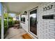 Inviting front porch with a classic rocking chair, brick accents, and a welcoming entrance at 1557 77Th N Ave, St Petersburg, FL 33702